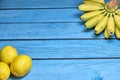 Freshly lemons and banana on rustic blue board background