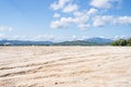 Freshly leveled construction site with mountains in background Royalty Free Stock Photo
