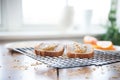 freshly made almond butter toast on a wire rack, steam rising