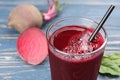 Freshly made beet juice in glass on blue table Royalty Free Stock Photo