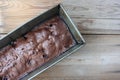 Freshly made brownie chocolate cake with cherries in a baking dish on a wooden table. Royalty Free Stock Photo