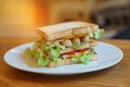 Freshly made club sandwiches served on a woode background