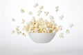 Freshly made crispy popcorn fall in pile on white background. Creative concept of floating healthy snacks.