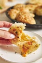 Freshly-made delicious cheese bubble pizza bread with ingredients and cheese on a white table