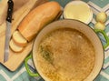 Freshly made French onion soup in a green pot