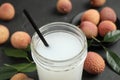 Freshly made lychee juice on grey table, closeup