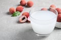 Freshly made lychee juice on light table, closeup. Space for text