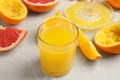 Freshly made orange juice, fruits and squeezer on table, closeup Royalty Free Stock Photo