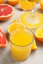 Freshly made orange juice, fruits and squeezer on table. Space for text Royalty Free Stock Photo