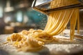 Freshly made pasta strands being cut and falling from a pasta machine onto a floured surface in a warm, rustic kitchen environment Royalty Free Stock Photo