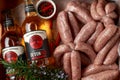 Freshly made raw butchers sausages in skins with Sanford orchards apple cider, Devon, United Kingdom, March 20, 2019.