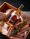 Freshly made raw butchers sausages in skins with Sanford orchards apple cider, Devon, United Kingdom, March 20, 2019.