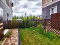 Freshly Mown Lawn in Residential Backyard on Overcast Day. Neatly trimmed grass behind a suburban home, bordered by a
