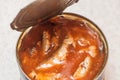 Freshly opened tin can with sprats in tomato sauce