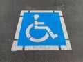 Freshly painted blue and white handicapped disabled parking sign on asphalt lot Royalty Free Stock Photo