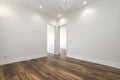 Freshly painted empty living room with dark wood floorboards