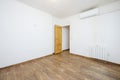 Freshly painted empty room with dark wood tile floor and pine wood door,