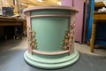 a freshly-painted round podium, ready for springtime blooms and other seasonal decor