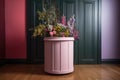 a freshly-painted round podium, ready for springtime blooms and other seasonal decor