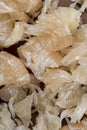 Freshly peeled pink pomelo on the table