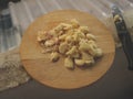 Freshly Peeled and Smashed Garlic on Wooden Cutting Board with Knife Royalty Free Stock Photo