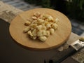 Freshly Peeled and Smashed Garlic on Wooden Cutting Board with Knife - Old Apartment Balcony Royalty Free Stock Photo