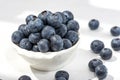 Freshly picked blueberries in a white vintage ceramic bowl. Selective focus