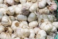 Freshly picked garlic in azure basket on market. Royalty Free Stock Photo