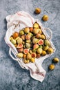 Freshly picked organic green figs in a basket on grey background Royalty Free Stock Photo