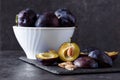 Freshly picked organic plums in bowl on table Royalty Free Stock Photo