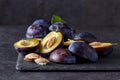 Freshly picked organic plums on dark table Royalty Free Stock Photo