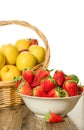 freshly picked organic strawberry and apples in a basket isolated over white background, healthy eating Royalty Free Stock Photo