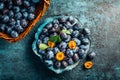 Freshly picked plums in a bowl and basket. Organic food