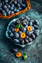 Freshly picked plums in a bowl and basket. Organic food