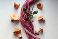 Freshly picked redheads with a striped napkin and a branch on the kitchen table, top view, close-up, the concept of using