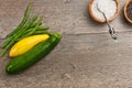 Freshly picked vegetables with wood bowls of sea salt and fresh pepper corns Royalty Free Stock Photo