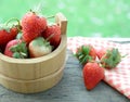 Freshly picked ripe strawberries bucket on a wooden background Royalty Free Stock Photo