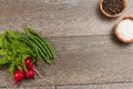 Freshly picked vegetables with wood bowls of sea salt and fresh pepper corns Royalty Free Stock Photo