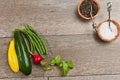 Freshly picked vegetables with wood bowls of sea salt and fresh pepper corns Royalty Free Stock Photo