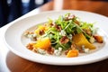 freshly plated roasted squash salad, blue cheese, walnuts, bacon bits