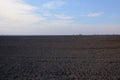 A freshly plowed farm field. Cultivated agricultural land. Landscape Royalty Free Stock Photo