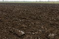 freshly plowed soil field in the foggy morning - close wide angle view with edge-to-edge sharpness