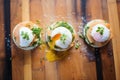 freshly poached eggs atop muffins, pre-sauce for a deconstructed look