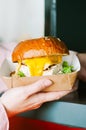 Freshly prepared cheeseburger in a paper box. Takeaway or delivery concept Royalty Free Stock Photo