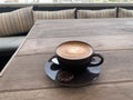 A freshly prepared cup of cortado coffee on an outdoor terrace