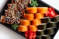 Freshly prepared rolls with raw salmon, kelp and eel in a sweet sesame sauce in a plastic square plate. Chinese food Royalty Free Stock Photo