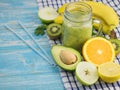 A freshly prepared smoothie of avocado, banana, orange, lemon and kiwi on a blue wooden table. Diet vegetarian food. Raw Royalty Free Stock Photo