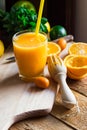 Freshly pressed citrus fruit juice from oranges lemons limes cumquat, glass, reamer, mint on table Royalty Free Stock Photo