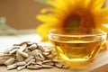 Freshly pressed sunflower oil, with sunflower in the background. AI generative Royalty Free Stock Photo