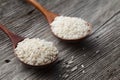 Freshly processed rice in the wooden spoon.  Rice close-up. Royalty Free Stock Photo